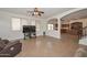 Bright living room with tile flooring, large windows, and an open view to the kitchen at 16112 W Durango St, Goodyear, AZ 85338