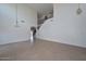 Open concept living room with tall ceilings, tile floors, and staircase at 16112 W Durango St, Goodyear, AZ 85338