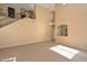 Spacious living room featuring a staircase, tile floors and neutral colored walls at 16112 W Durango St, Goodyear, AZ 85338