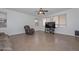 Cozy living room with tile flooring and a large TV at 16112 W Durango St, Goodyear, AZ 85338