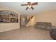 Inviting living room showcasing tile flooring and seamless transition to the kitchen and staircase at 16112 W Durango St, Goodyear, AZ 85338