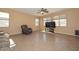 Bright living room with tile floors, large windows, and comfortable seating arrangement at 16112 W Durango St, Goodyear, AZ 85338