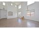 Bright living room featuring soaring ceilings, clerestory windows, and tile flooring at 16112 W Durango St, Goodyear, AZ 85338