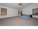 Bright main bedroom with carpet floors and lots of natural light at 16112 W Durango St, Goodyear, AZ 85338