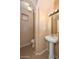 Powder room with pedestal sink, mirror, light fixture, and small window at 16112 W Durango St, Goodyear, AZ 85338