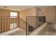 Staircase landing with black iron railing and neutral walls at 16112 W Durango St, Goodyear, AZ 85338