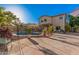 Large backyard showcasing desert landscaping, pool, fence, patio, and a two-story home at 16153 W Lisbon Ln, Surprise, AZ 85379
