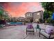 Beautiful backyard with a pool, patio furniture, pavers, and string lights, perfect for outdoor entertaining at 16153 W Lisbon Ln, Surprise, AZ 85379