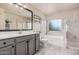 Well-lit primary bath includes a bathtub, a shower and a modern sink at 16153 W Lisbon Ln, Surprise, AZ 85379