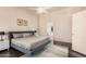 Bedroom with a stylish bed, ensuite bathroom, and modern decor at 16153 W Lisbon Ln, Surprise, AZ 85379