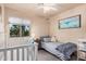 Bedroom with a crib, a daybed and a charming whale themed decor at 16153 W Lisbon Ln, Surprise, AZ 85379