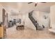 Open dining area with a modern chandelier, seamlessly connecting to the kitchen and staircase at 16153 W Lisbon Ln, Surprise, AZ 85379