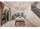 Bright dining area connects seamlessly to the kitchen with a modern chandelier and access to outdoor space at 16153 W Lisbon Ln, Surprise, AZ 85379