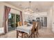 Inviting dining area adjacent to a kitchen with sliding glass door, table and chairs, and modern light fixture at 16153 W Lisbon Ln, Surprise, AZ 85379