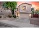 Well-maintained two-story home with a two-car garage, complemented by tidy landscaping and a paved driveway at 16153 W Lisbon Ln, Surprise, AZ 85379