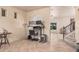 Bright hallway with tile flooring leads to the stairs and living room, complete with a desk area for convenience at 16153 W Lisbon Ln, Surprise, AZ 85379