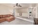 Spacious living room with brown sectional sofa and large windows providing plenty of light at 16153 W Lisbon Ln, Surprise, AZ 85379