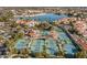 Aerial view showcasing tennis courts, pool, community lake and surrounding residential area at 1633 E Lakeside Dr # 39, Gilbert, AZ 85234