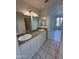 Bathroom featuring dual sinks with granite countertops, bright lighting, and an adjacent room at 1633 E Lakeside Dr # 39, Gilbert, AZ 85234
