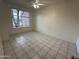 Bright bedroom featuring tile flooring and a large window at 1633 E Lakeside Dr # 39, Gilbert, AZ 85234
