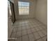 Bright bedroom with tiled floor, window with blinds, and mirrored closet at 1633 E Lakeside Dr # 39, Gilbert, AZ 85234