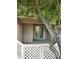 Covered patio with a white lattice fence, large tree, and sliding glass doors to the home at 1633 E Lakeside Dr # 39, Gilbert, AZ 85234