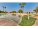 Community pool with a sandy beach, lounge chairs, and clear blue water at 1633 E Lakeside Dr # 39, Gilbert, AZ 85234
