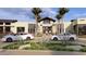 Stylish community center entrance with ample parking, modern architecture, and desert landscaping at 16932 W Desert Hollow Dr, Surprise, AZ 85387
