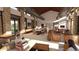 Spacious community center with seating, tables, large TV, and ample natural light from large windows at 16932 W Desert Hollow Dr, Surprise, AZ 85387