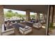 Covered outdoor lounge with comfortable seating and stone columns, ideal for relaxation and socializing at 16932 W Desert Hollow Dr, Surprise, AZ 85387