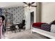 Bedroom featuring a striking damask wallpaper, desk, and bed with a red throw at 19820 N 13Th Ave # 255, Phoenix, AZ 85027