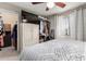 Bedroom showing a ceiling fan, window with curtains, wardrobe, and cozy bed at 19820 N 13Th Ave # 255, Phoenix, AZ 85027