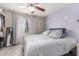 Comfortable bedroom with a ceiling fan, plush bedding, and a bright window at 19820 N 13Th Ave # 255, Phoenix, AZ 85027