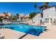 Community pool with lounge seating, tables and umbrellas, and well-kept landscaping at 19820 N 13Th Ave # 255, Phoenix, AZ 85027