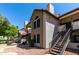 Inviting condo exterior showcasing stucco walls, red tile roof, and wrought iron stair rails at 19820 N 13Th Ave # 255, Phoenix, AZ 85027