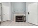 Cozy living room displaying a traditional fireplace with white mantle and neutral-toned tile flooring at 19820 N 13Th Ave # 255, Phoenix, AZ 85027