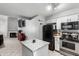 Well-lit kitchen with a black refrigerator, stainless steel range, granite countertops, and an island at 19820 N 13Th Ave # 255, Phoenix, AZ 85027