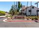 Community signage, Ramblewood North, with manicured bushes and palm tree landscaping at 19820 N 13Th Ave # 255, Phoenix, AZ 85027