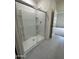 Modern walk-in shower features sliding glass doors and built-in shelving for organization at 2025 E Bucking Bronco Dr, San Tan Valley, AZ 85140
