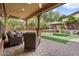 Outdoor living space featuring an outdoor kitchen, patio seating, and manicured green space at 21014 W Cora Vista --, Buckeye, AZ 85396