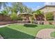 Inviting backyard with artificial turf, a built-in barbecue area, comfortable seating and shade at 21014 W Cora Vista --, Buckeye, AZ 85396