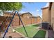 Backyard with a swing set and synthetic grass offers a clean and safe play area at 21014 W Cora Vista --, Buckeye, AZ 85396