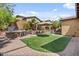 Backyard featuring an outdoor kitchen, patio seating, and manicured green space at 21014 W Cora Vista --, Buckeye, AZ 85396