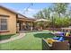 Spacious backyard includes an outdoor living area, lush green turf, mature trees, and an outdoor kitchen at 21014 W Cora Vista --, Buckeye, AZ 85396