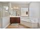 Bathroom featuring a glass shower, vanity with sink, soaking tub, and wood-look floors at 21014 W Cora Vista --, Buckeye, AZ 85396
