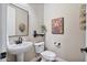 Stylish powder room with a pedestal sink, modern fixtures, and decorative artwork at 21014 W Cora Vista --, Buckeye, AZ 85396