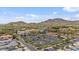 Aerial view of a commercial area, with mountain views, lush trees, parking spaces, and Mediterranean style architecture at 21014 W Cora Vista --, Buckeye, AZ 85396