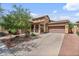 Charming single-Gathering home features a two-car garage, manicured front yard, and desert landscaping at 21014 W Cora Vista --, Buckeye, AZ 85396