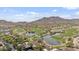 Picturesque aerial view of a golf course with water features, lush trees, and nearby houses at 21014 W Cora Vista --, Buckeye, AZ 85396