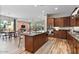 Kitchen features stainless appliances, wood cabinets, granite counters, and a breakfast bar at 21014 W Cora Vista --, Buckeye, AZ 85396